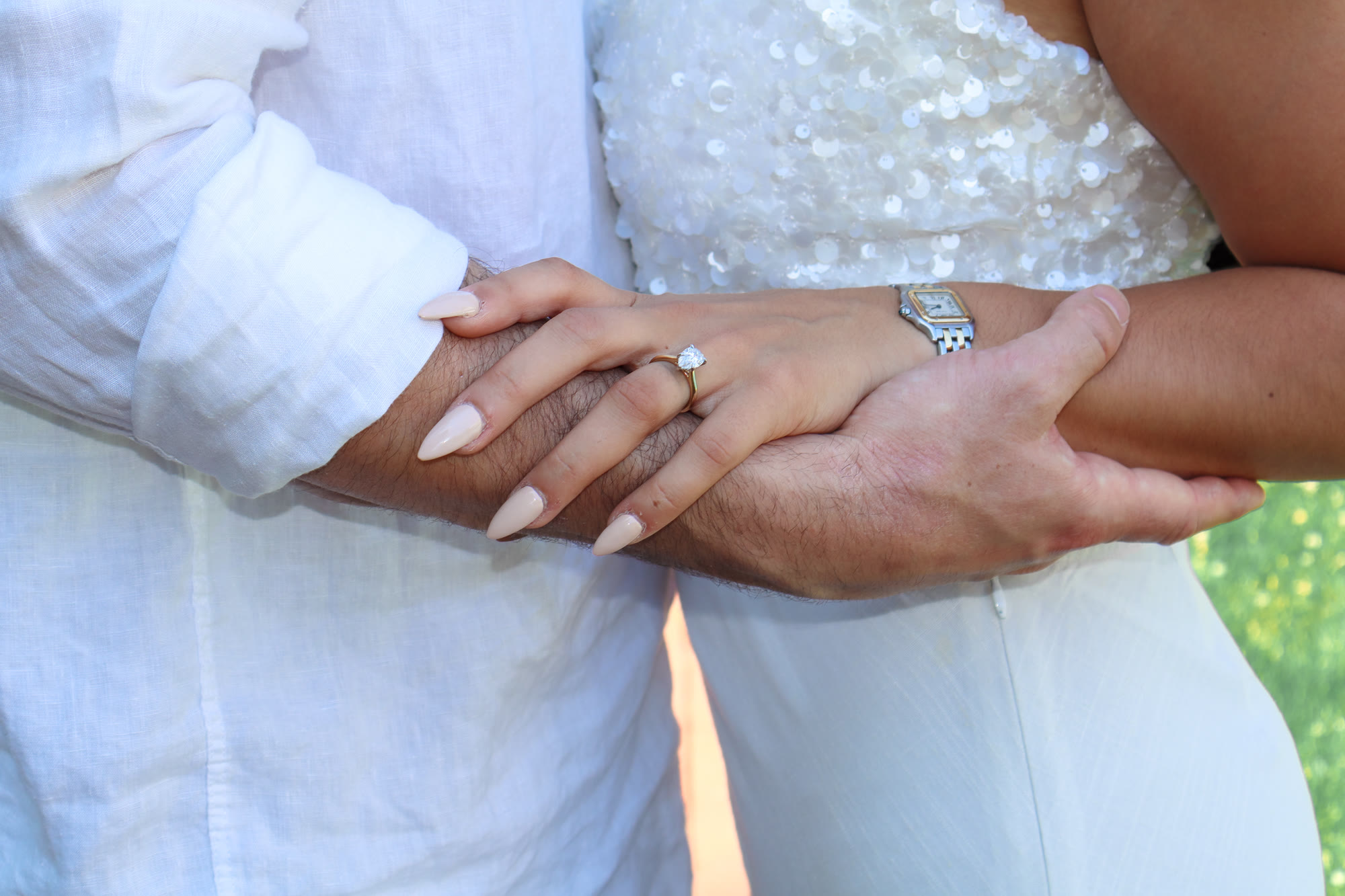 Engagement ring detail - hands intertwined